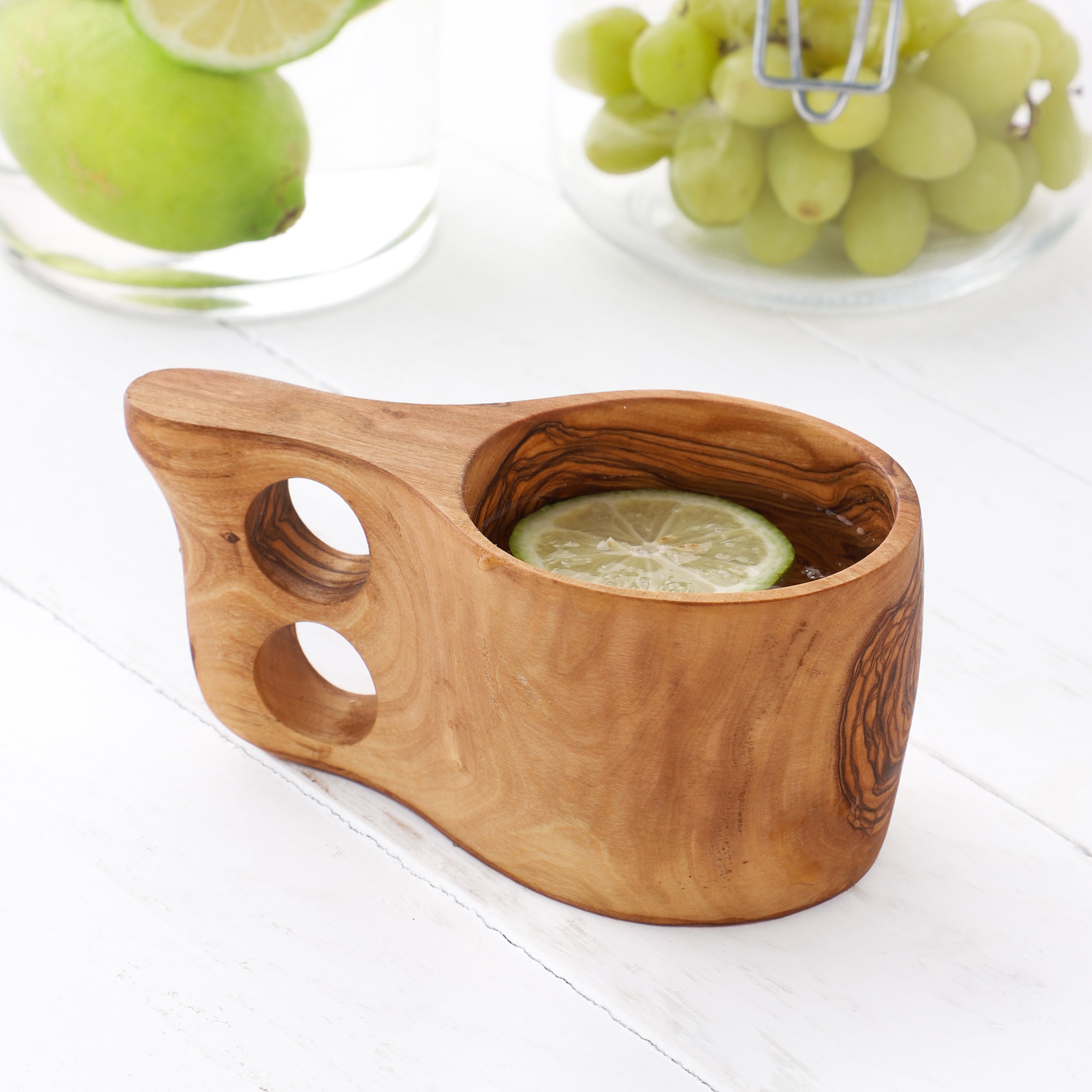 Artisanal Olive Wood Kuksa Cup, beautifully carved with a comfortable grip handle, making it perfect for sipping your favorite beverage while appreciating the cup's organic beauty and craftsmanship.